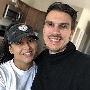 Happy couple in modern kitchen, smiling during home tour with a real estate agent.